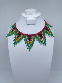 This beautiful beaded necklace is hand-woven by the women of the Embera Chami Indigenous Tribe of Colombia Artisan Beaded Necklace With Adjustable Length, Artisan Adjustable Beaded Necklaces With Colorful Beads, Artisan Adjustable Colorful Beaded Necklaces, Artisan Beaded Crystal Necklaces, Artisan Beaded Bib Necklace With Adjustable Fit, Artisan Beaded Adjustable Necklaces, Traditional Adjustable Necklaces With Colorful Beads, Artisan Beaded Adjustable Necklace, Traditional Beaded Crystal Necklaces With Round Beads