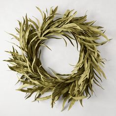 a wreath made out of green leaves on a white background