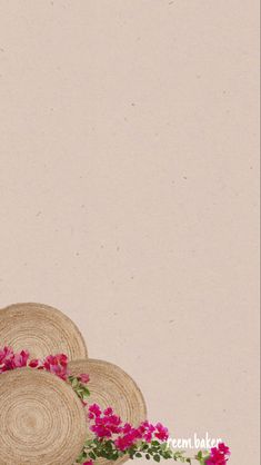 three straw hats with pink flowers in front of a beige background