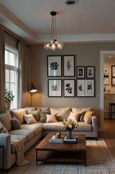 a living room filled with furniture and pictures hanging on the wall above it's coffee table