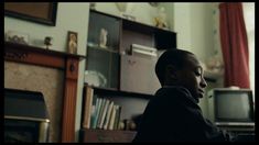 a young man sitting in front of a computer monitor