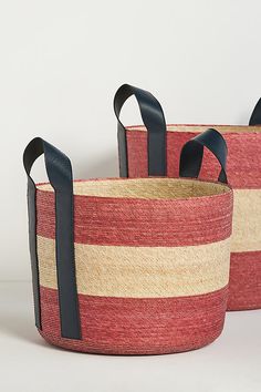 two red and beige baskets with black handles