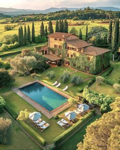 an aerial view of a large house with a swimming pool in the middle of it