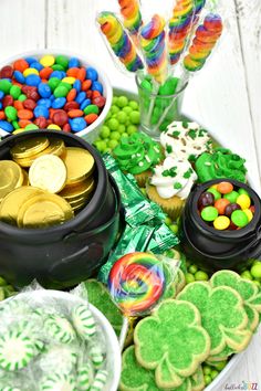 a table topped with lots of different types of candies and cookies on top of it