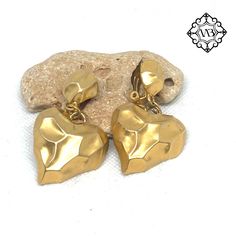 Vintage statement gold tone heart clip on earrings Beautiful Vintage Statement very heavy clip on earrings from the 90's. They are in a very good vintage condition. Rare and collectible piece. The size is: 6x3.2 cm the weight is: 18.4 g each  These beautiful hanging clip on earring could be a nice present for statement metal clip on earrings lovers or for collectors. They are very fashionable. Please feel free to contact me if you have any questions.  Check out my shop where you can find a lot o Gold Metal Clip-on Earrings For Anniversary, Vintage Gold Double Heart Earrings, Gold Double Heart Vintage Earrings, Gold Clip-on Heart Earrings For Anniversary, Formal Heart-shaped Clip-on Earrings, Vintage Gold Heart Earrings, Gold Heart-shaped Clip-on Earrings For Anniversary, Gold Heart-shaped Clip-on Jewelry, Gold Heart-shaped Clip-on Earrings