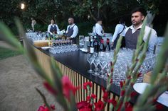 a man standing at a bar filled with wine glasses