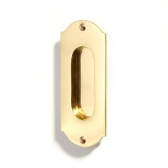 a brass door handle on a white wall