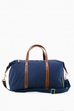 Navy Canvas Heritage Weekender Duffel Luxury Blue Canvas Bag, Modern Leather Trim Duffle Bag For Overnight Trips, Modern Duffle Bag With Leather Handles For Overnight Trips, Modern Weekender Bag With Adjustable Strap For Overnight Trips, Modern Duffle Bag With Adjustable Strap For Overnight Trips, Luxury Bags With Adjustable Strap For Overnight Trips, Luxury Bag With Adjustable Strap For Overnight Trips, Modern Bags With Adjustable Strap For Overnight Trips, Modern Weekender Bag With Leather Trim For Overnight Trips