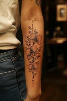 a woman's arm with flowers on it