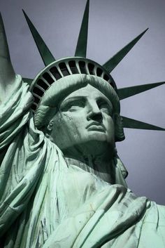 the statue of liberty is shown against a blue sky