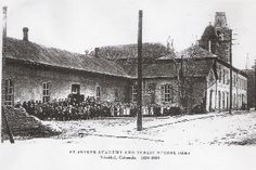 an old black and white photo of people standing in front of a building