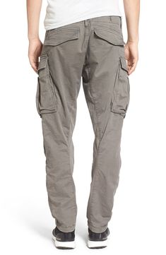 Stretch-cotton pants in a tapered profile rock a modern, utilitarian look with cargo-style pockets and ergonomic seaming for a more active fit. 32" inseam; 14" leg opening; 10" front rise; 15" back rise (size 32) Zip fly with button closure Side slant pockets; back flap pockets; side cargo pockets 97% cotton, 3% elastane Machine wash, dry flat Imported Urban Tapered Leg Cargo Jeans, Rugged Straight Leg Bottoms With Cargo Pockets, Combat Cargo Pants With Relaxed Fit And Side Pockets, Utility Parachute Pants With Hip Pockets And Tapered Leg, Urban Cargo Jeans With Tapered Leg, Urban Style Tapered Leg Cargo Pants With Multiple Pockets, Relaxed Fit Cotton Cargo Jeans With Functional Pockets, Urban Cargo Pants With Tapered Leg And Hip Pockets, Utility Cargo Pants With Tapered Leg