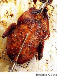 a roasting rack with a whole chicken on it