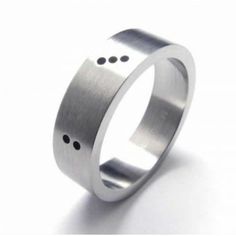 a stainless steel ring with holes in the middle and two black dots on each side