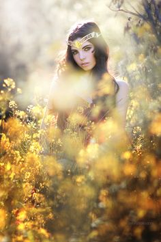 a woman in a field with yellow flowers