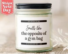 a glass jar with a label that says smells like the opposite of a gym bag