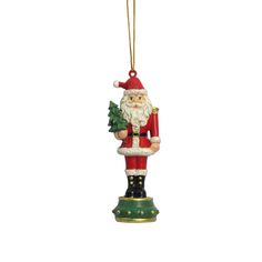 a christmas ornament with a santa clause holding a tree