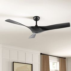 a black ceiling fan in a white room