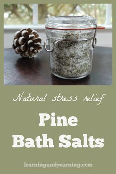 pine bath salts in a glass jar next to a pine cone