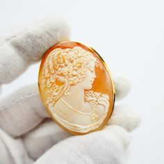 Antique 750 18k Gold Oval Cameo brooch or pendant In good antique condition, pre-owned. shell is signed NV there are lines on the back of the shell Total weight: 10.6g - Gold Tested Measures approx. 2X1.5 inches - See photos for details.  **We do not use any filters for our pictures and try to capture the real colors of the item. What you see is what you get! Don't hesitate if you have questions** Classic Gold Intaglio Brooch, Classic Gold Brooch With Intaglio Detail, Classic Gold Intaglio Brooches, Classic Gold Brooches With Intaglio, Luxury Yellow Gold Cameo Brooch, Yellow Gold Medallion Brooches, Yellow Gold Medallion Brooches As Gift, Luxury Oval Cameo Brooch, Gold Oval Cameo Brooch