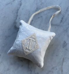 a small white bag sitting on top of a marble counter