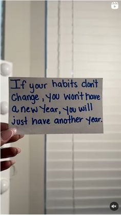 someone holding up a note that says if your habitts don't change, you won't have a new year, you will just have another year