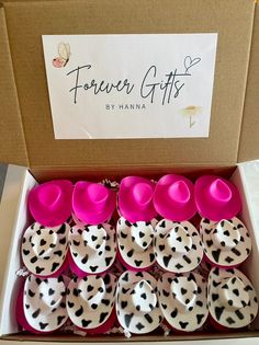 a box filled with lots of pink and black polka dot covered cups next to a sign that says flower gifts