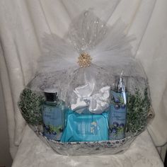 a basket filled with personal care items on top of a toilet covered in tulle