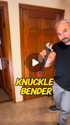 a man holding a giant wrench in his hand with the words knuckle bender on it