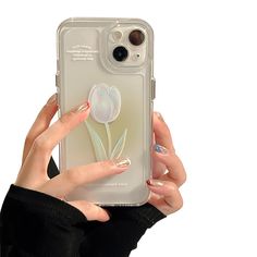 a woman holding up her phone case with a flower on the front and bottom cover