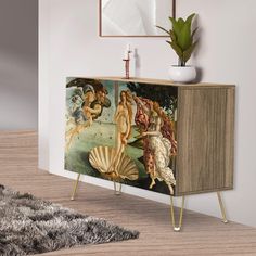 a sideboard with paintings on it in a room next to a rug and potted plant