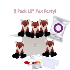 five fox stuffed animals sitting on top of a white box next to an envelope and other items