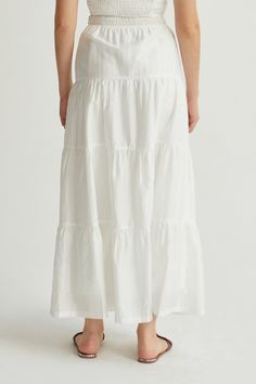 Made with a delicate Tencel-blend, the Daisy Tiered Maxi Skirt is high-waisted with a side hook & eye and invisible zipper closure, partial smocked waist at back, and tiered skirt detail. Style it with the matching Manny Shirred Crop Top. High waisted Side hidden zipper closure Back partial smocked waist detail Tiered skirt Lined Hand wash Imported Self: 85% Tencel, 15% Polyester Lining: 98% Polyester, 2% Spandex Style No. CS9185 Model is wearing size S Model InfoHeight: 5'6" I Bust: 32” I Waist Shirred Crop Top, Maxi Jumpsuit, Tiered Maxi Skirt, Tier Skirt, Casual Sets, Tiered Skirt, Hook Eye, Cami Dress, Outerwear Coats