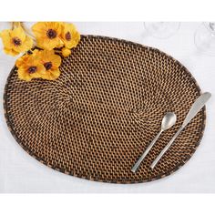 a place setting with yellow flowers and silverware