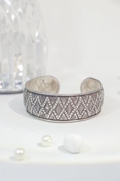 Enhance Your Style with Elegant Handcrafted Silver Jewelry Discover the timeless elegance of this handcrafted pure silver cuff bracelet, featuring an intricate geometric design that adds a touch of sophistication to any outfit. Weighing 33 grams, this exquisite piece is meticulously crafted by skilled artisans with over 30 years of experience. The bracelet is made from 95% pure silver, ensuring both durability and luxurious style. Its adjustable nature ensures a comfortable fit for any wrist size, making it perfect for both daily wear and special occasions. Why You'll Love It: Exquisite Craftsmanship: Handcrafted with care and precision, this bracelet showcases the superior skill of our artisans, ensuring a high-quality piece that stands the test of time. High-Quality Materials: Made from Handcrafted Silver Jewelry, Silver Cuff Bracelet, Silver Cuff, Pure Silver, Meaningful Gifts, 30 Years, Geometric Design, Cuff Bracelet, Cuff Bracelets