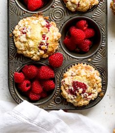 muffins with fresh raspberries in a muffin tin ready to be eaten