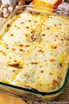 a casserole dish filled with cheese and mushrooms