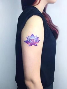 a woman with a purple flower tattoo on her arm