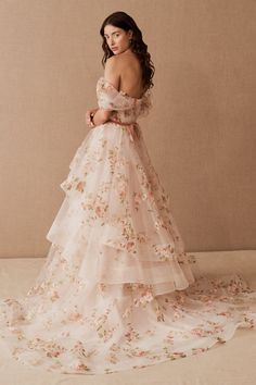 a woman in a wedding dress with flowers on it