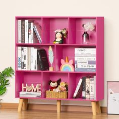 a pink book shelf filled with lots of books