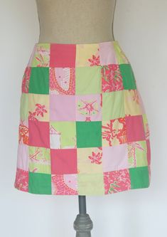 "\"Anything is possible with sunshine and a little pink.\" -Lilly Pulitzer     There is lots of pink in this Purdy little patchwork skirt. The print is a patchwork composed of solid squares of bright and pale pink and bright and pale green. The patterned squares consist of monkeys, palm trees and flowers. The skirt is fully lined with a 6-1/2 inch zipper in the back. Size 2. *Please see measurements.    Measurements:    -Waist: 27 inches    -Hips: 38 inches    -Width at hem: 39 lnches    -Length: 17 inches   For more lovely handmade, vintage and vintage-inspired , and handmade items,shop: www.etsy.com/shop/MadeleinesCollection" Spring Pink Patchwork Skirt, Casual Pink Patchwork Skirt, Pink Cotton Patchwork Skirt, Fitted Pink Patchwork Skirt, Fun Pink Skirt For Spring, Pink Lilly, Trees And Flowers, Pink Lillies, Vintage Lilly Pulitzer