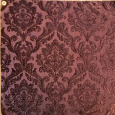 the fabric is very dark purple and has an intricate design on it's side