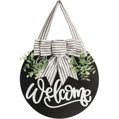 a black and white welcome sign with a bow on the front that says,'welcome '