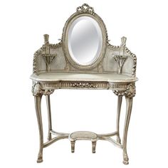 an ornate silver vanity with mirror and stool