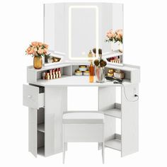 a white vanity table with drawers and mirror