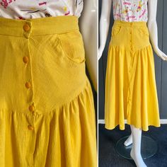 Loose vintage 80s skirt in sunny yellow color, in fine, slightly translucent material, crepe texture; without a label we will bet on viscose. Fitted waist and hips, Italian pockets, buttoned closure all over the front. DooWop likes the bright color of this piece to perhaps wear over a petticoat, because its fabric is translucent even around the waist. Vintage condition worn but good, we note when looking closely a discreet brown mark in the folds of the skirt, see last image. T-shirt sold separa Retro Relaxed Skirt For Summer, Yellow Retro Skirt With Relaxed Fit, Vintage Skirt For Summer Day Out, Vintage Summer Skirt For Day Out, Yellow Long Skirt For Summer, Yellow Full Maxi Skirt For Spring, Vintage Pleated Skirt For Summer, Vintage Flared Skirt For Summer, Yellow High Waist Pleated Skirt