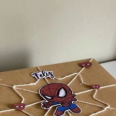 a cardboard box with a spiderman sticker on it