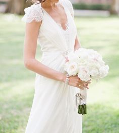 a woman in a wedding dress holding a bouquet