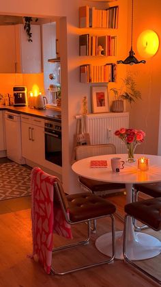 a kitchen with a table and two chairs in the center, next to an oven