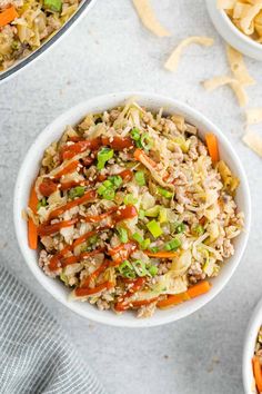 two bowls filled with rice, carrots and other food items next to some chips